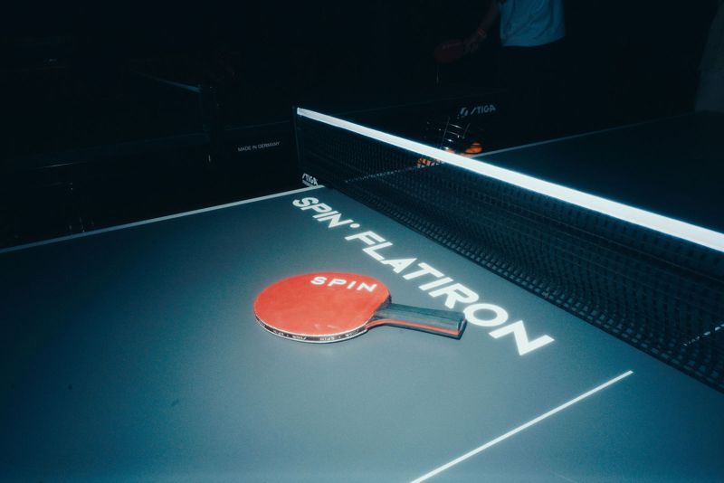 Red paddle resting on a Spin Flatiron table