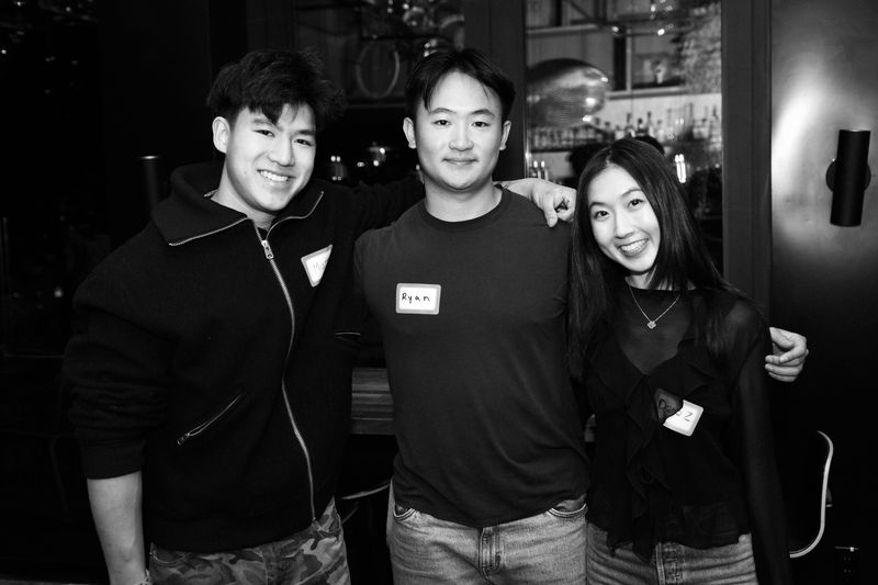 Three guests posing together, in black and white