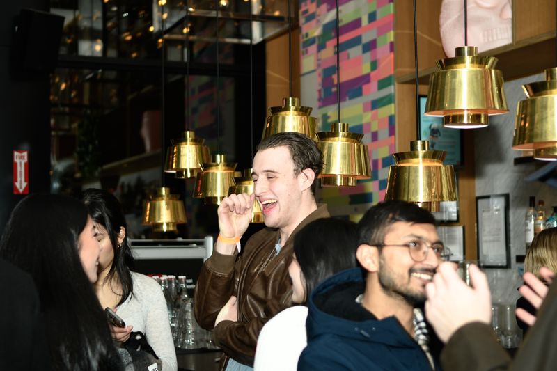 Guests laughing together at the bar